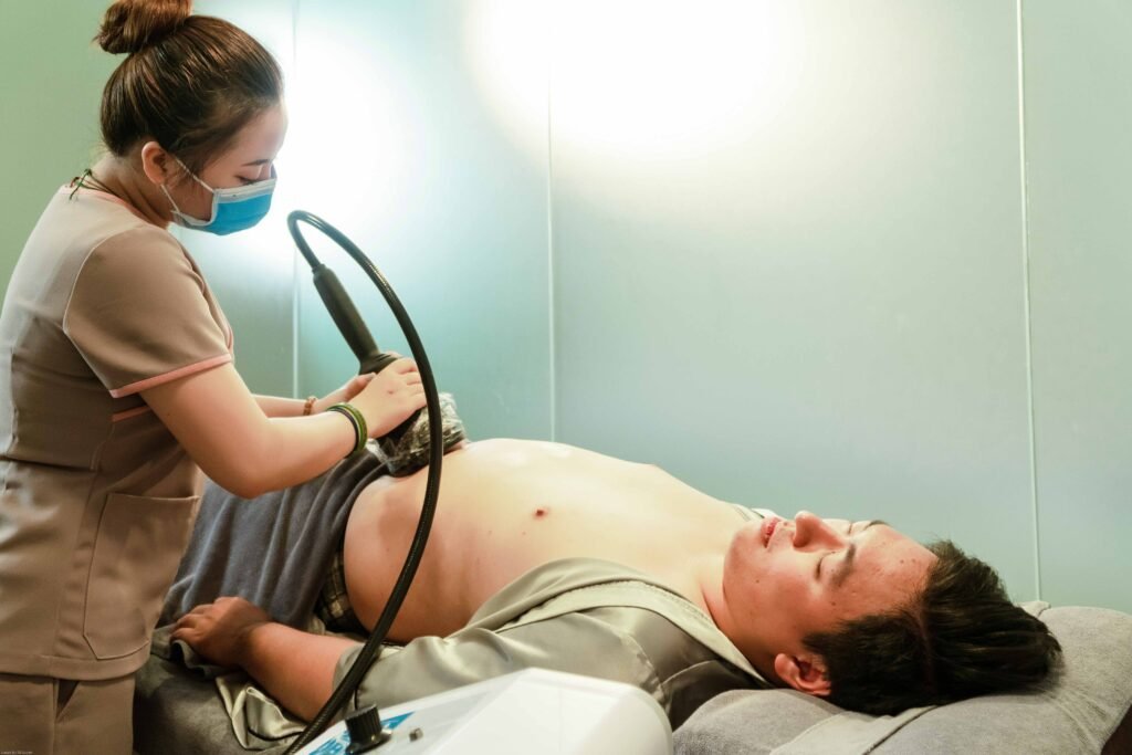 A healthcare professional performs an ultrasound on a patient in a medical clinic.